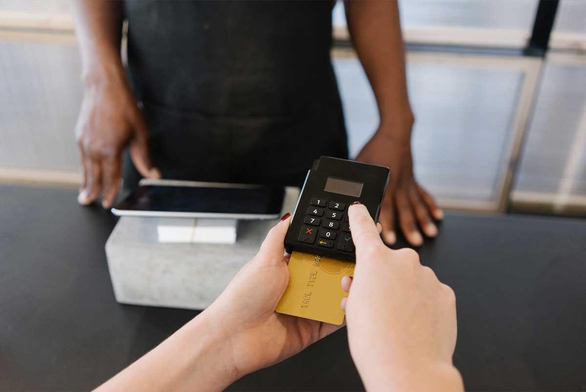 Cashier inserting card chip into reader