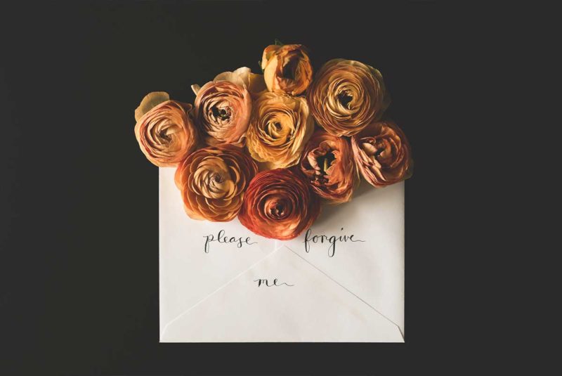 A letter with "please forgive me" written