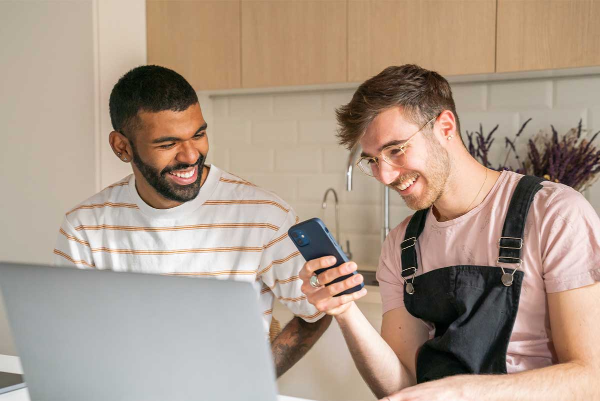 two men looking at a phone together
