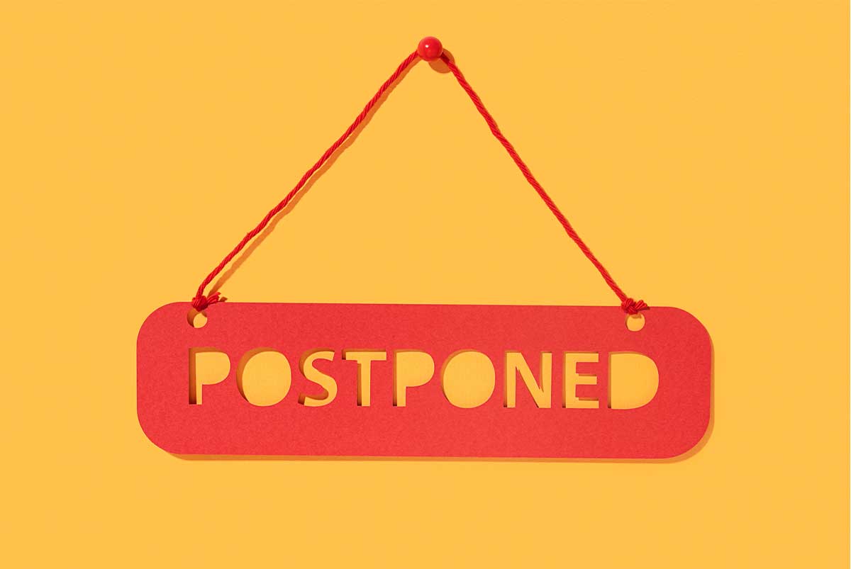 Postponed sign on yellow background