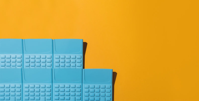a group of blue calculators on an orange background