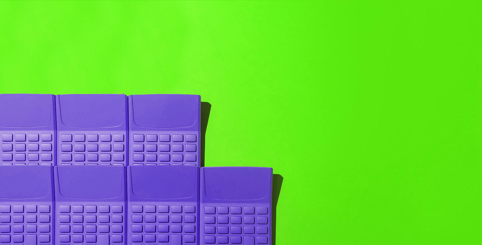 a group of purple calculators on a green background