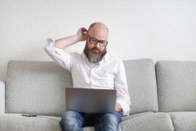 A man writing a goodwill letter on his laptop.