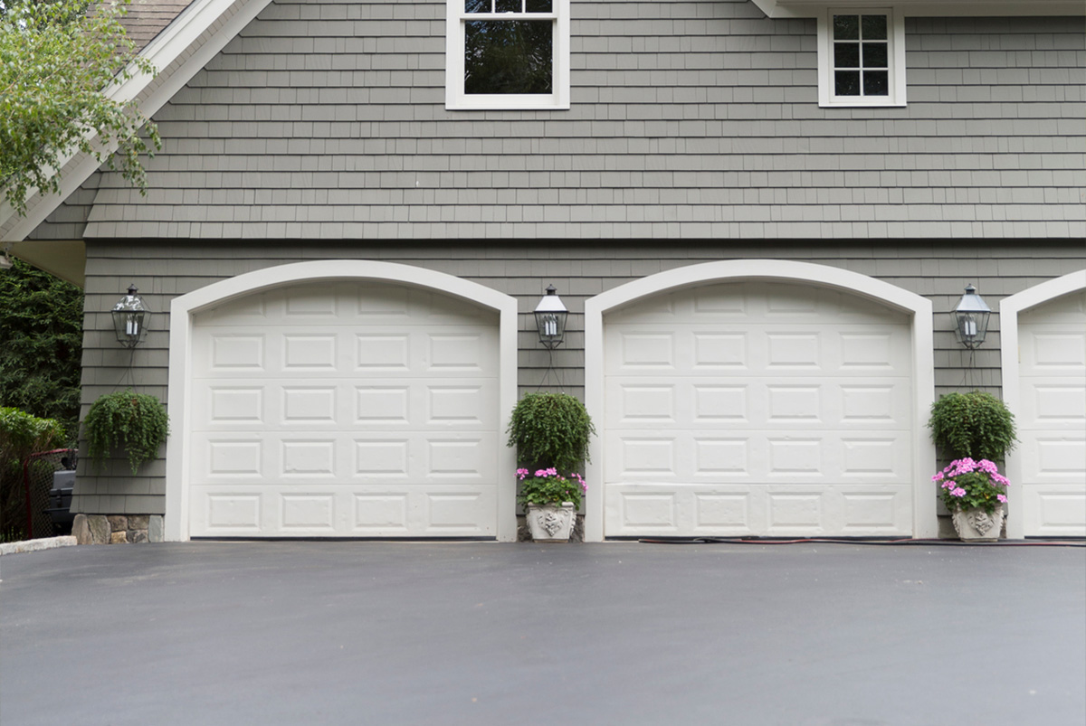 Exterior of home with driveway and garage door