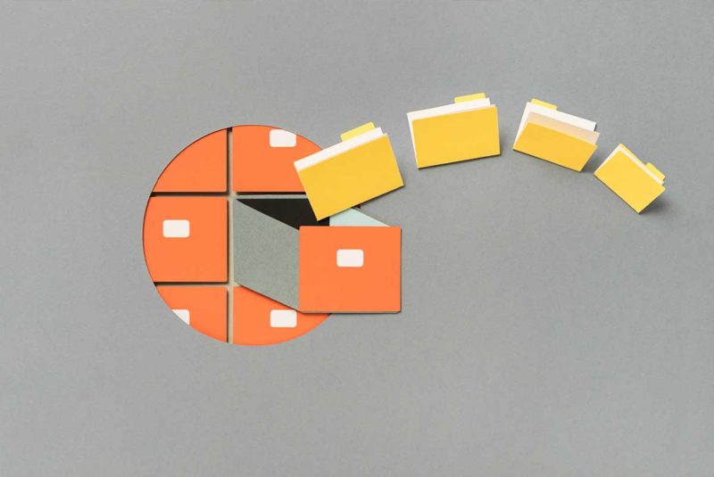 A circular view of an orange filing cabinet with yellow folders coming out