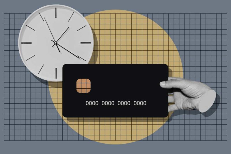 clock and hand holding credit card