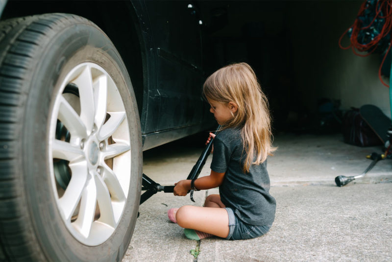child changing a tire