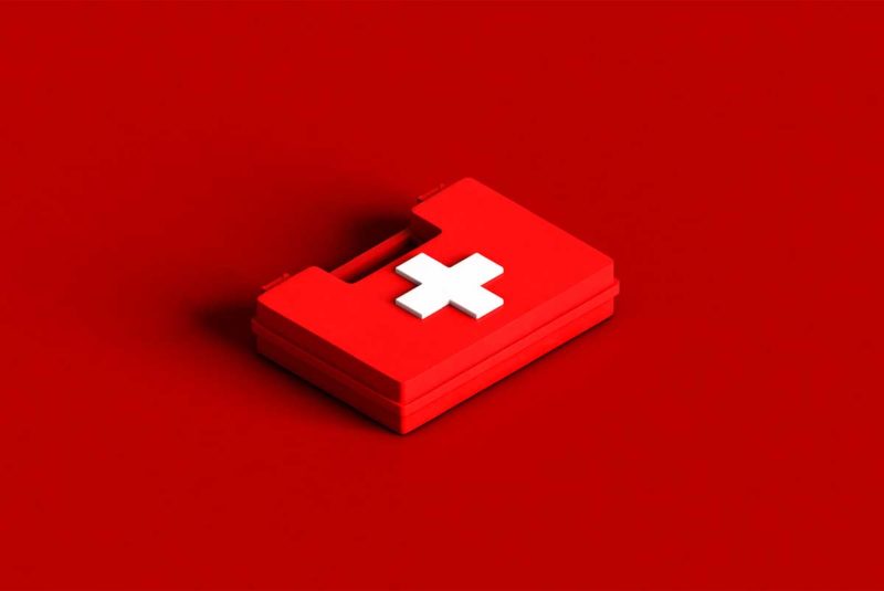 Conceptual image of a first aid kit against a red background