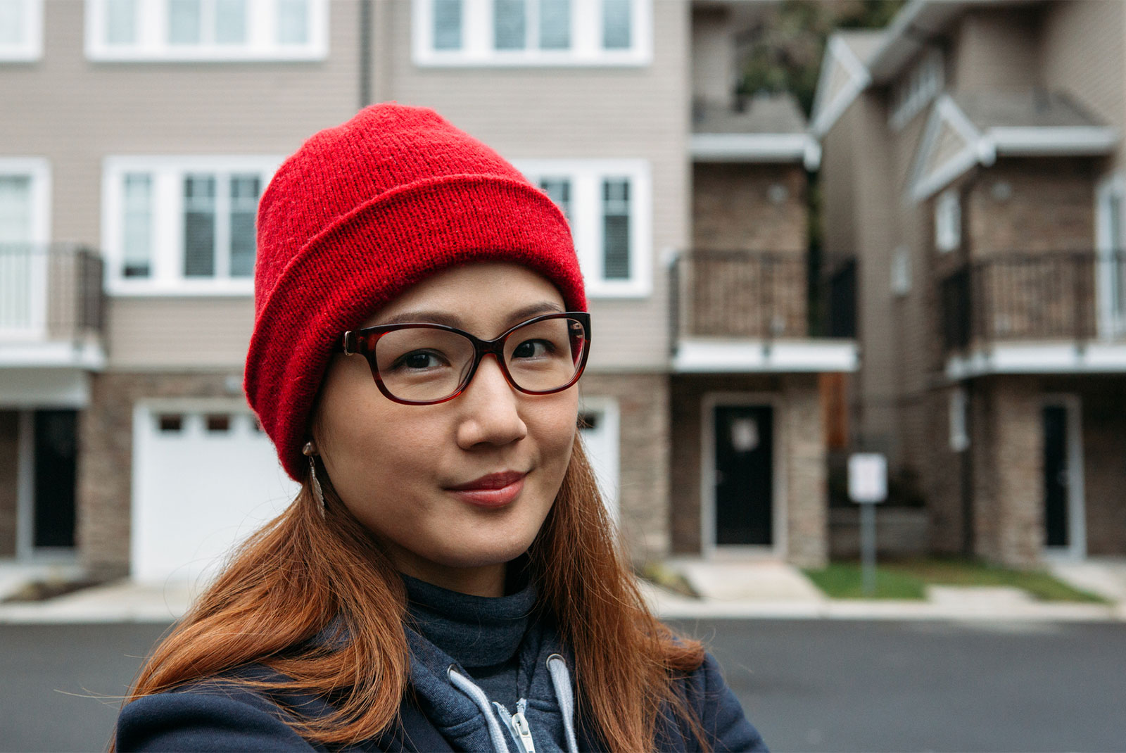 woman with red beanie thinking about paying off student loans