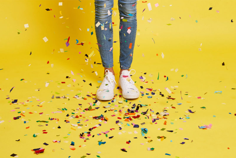 legs in blue jeans with confetti