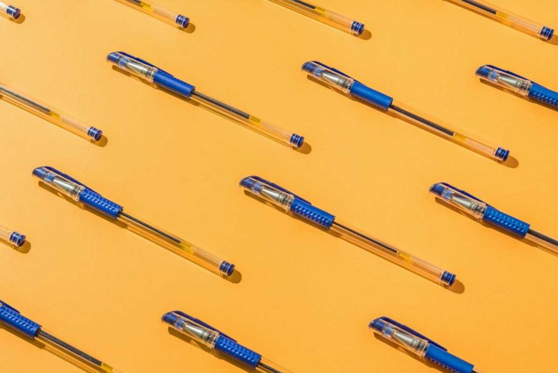 pens on yellow background
