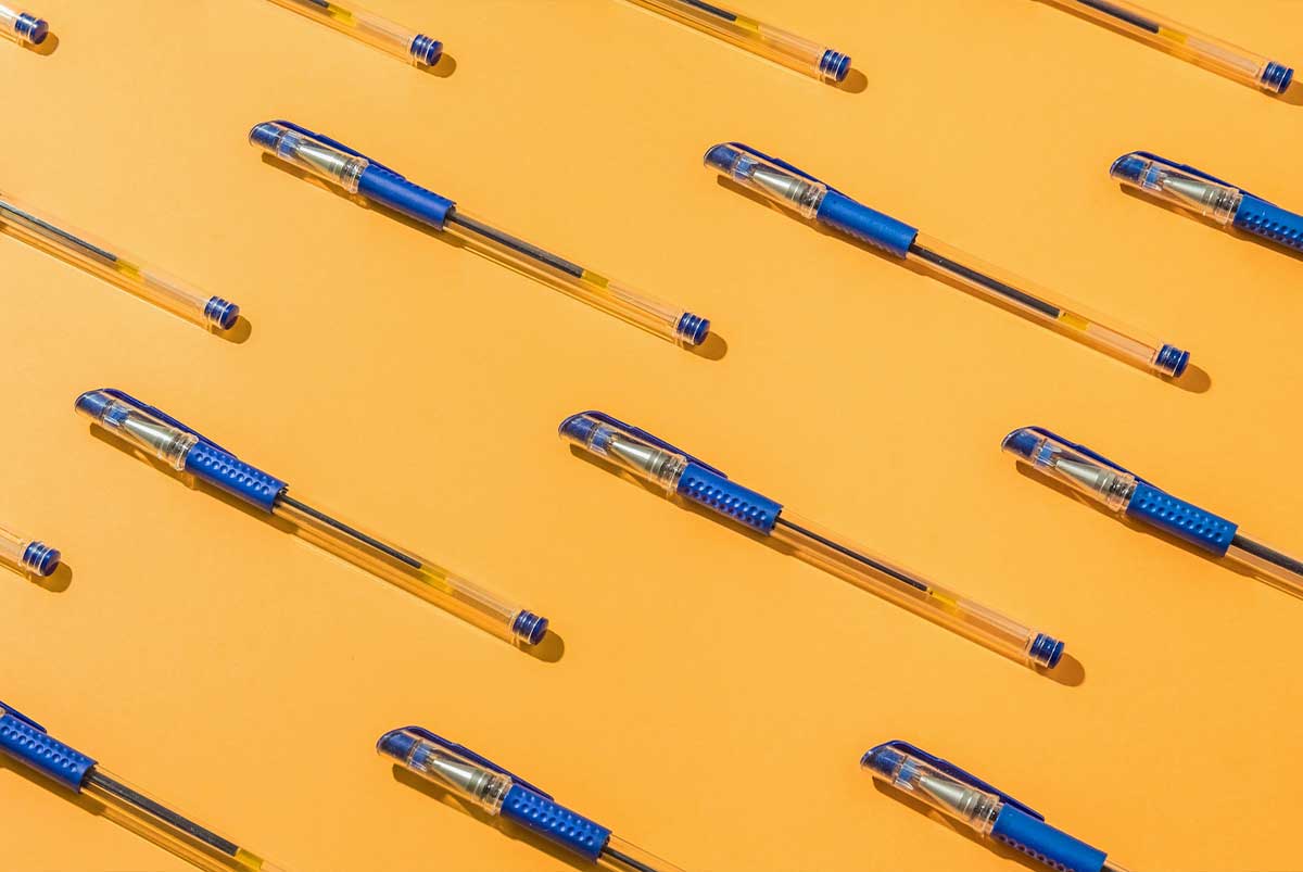 pens on yellow background