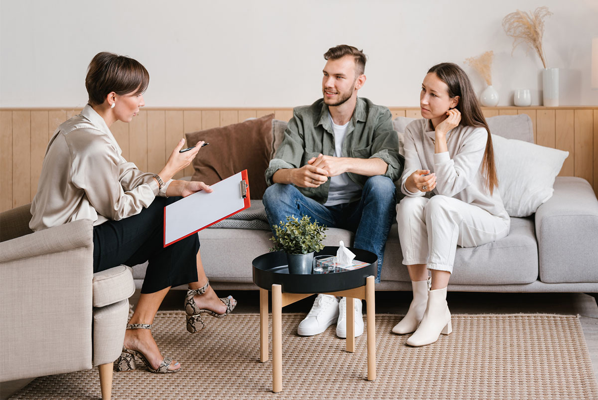 A young couple discusses their options with a real estate agent.