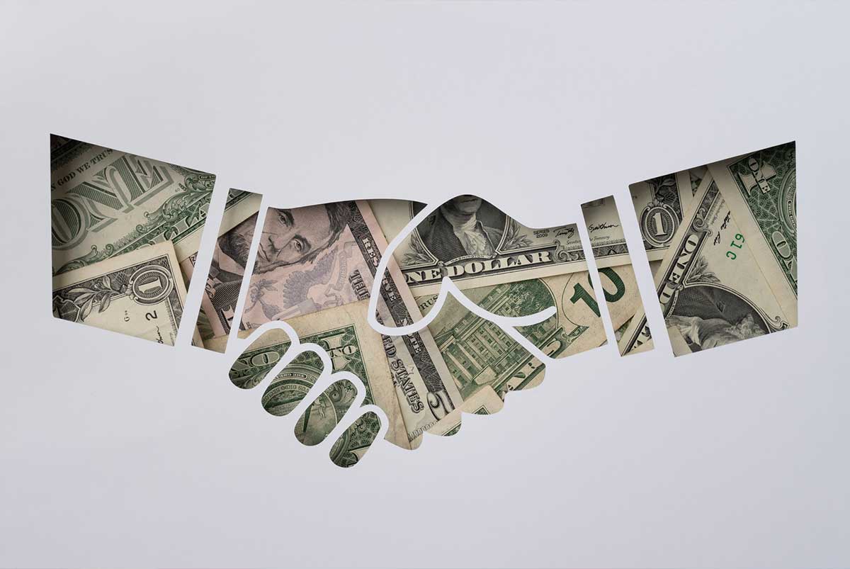 Handshake made of dollar bills
