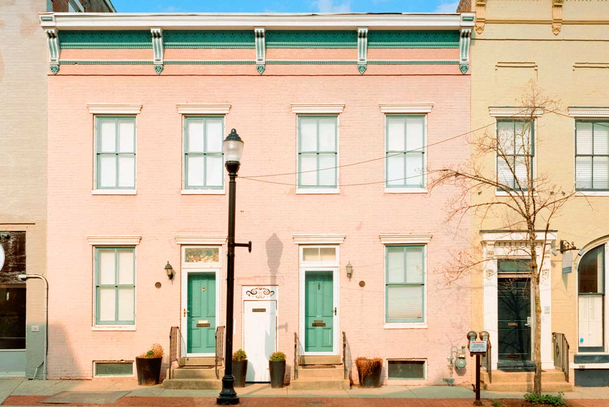 Multifamily home with pink walls and green doors