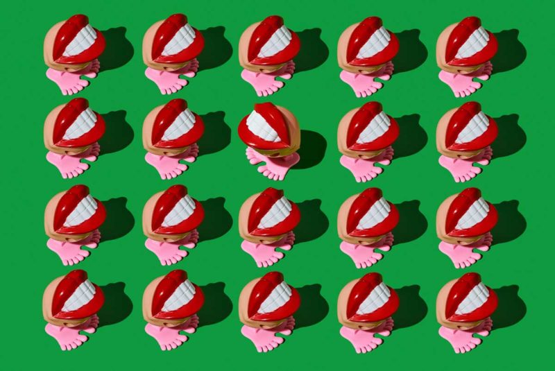 Four rows of toy mouths with feet with one toy facing in the reverse direction