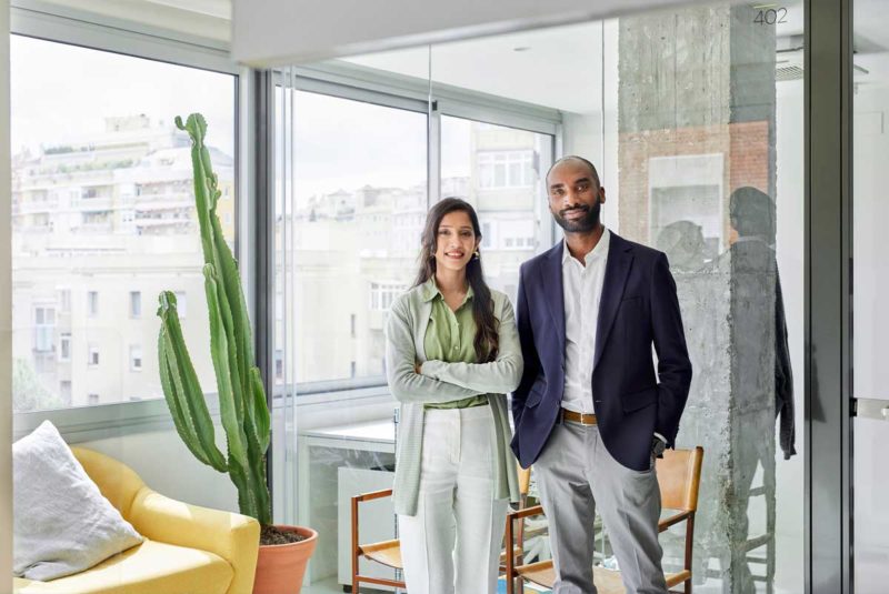two people standing in an office