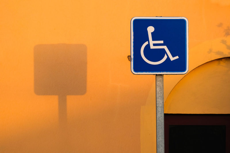 Orange background with blue disabilities access sign