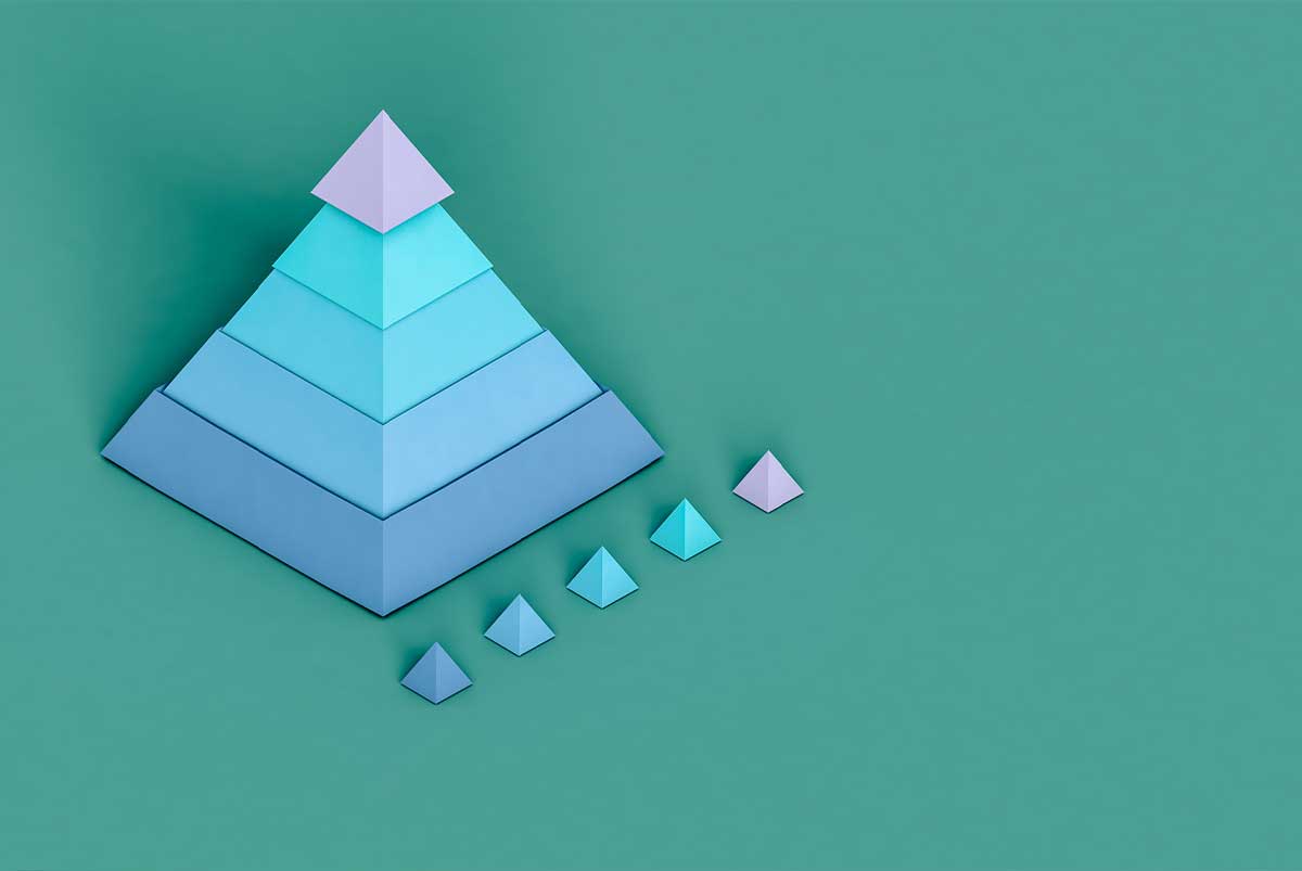 Conceptual image of a large pyramid next to five small pyramids of equal size