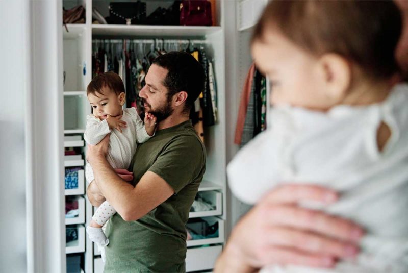 Father holding child looking in the mirror