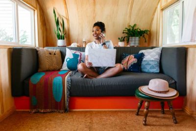 Woman on couch talking on phone