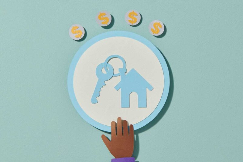 Conceptual image showing an circle icon of a house and keys with dollar signs above it.