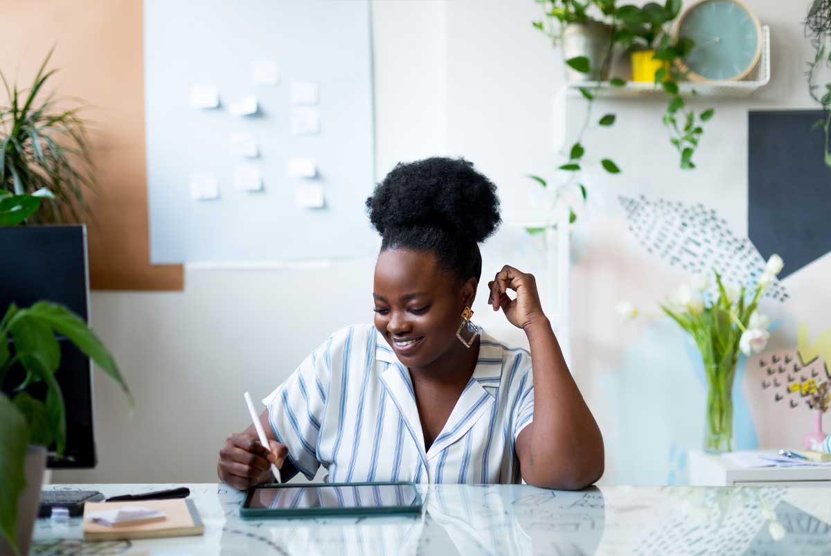 Black woman working at her desk in her home office