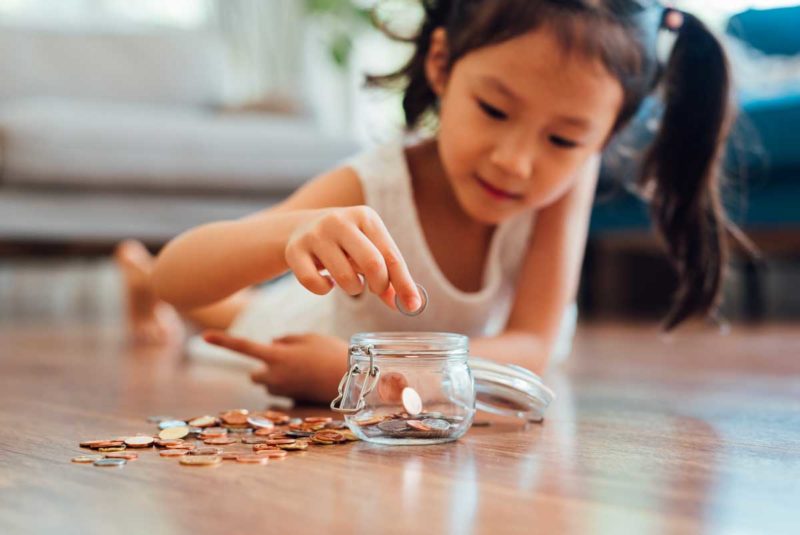 Girl counting coins in a jar