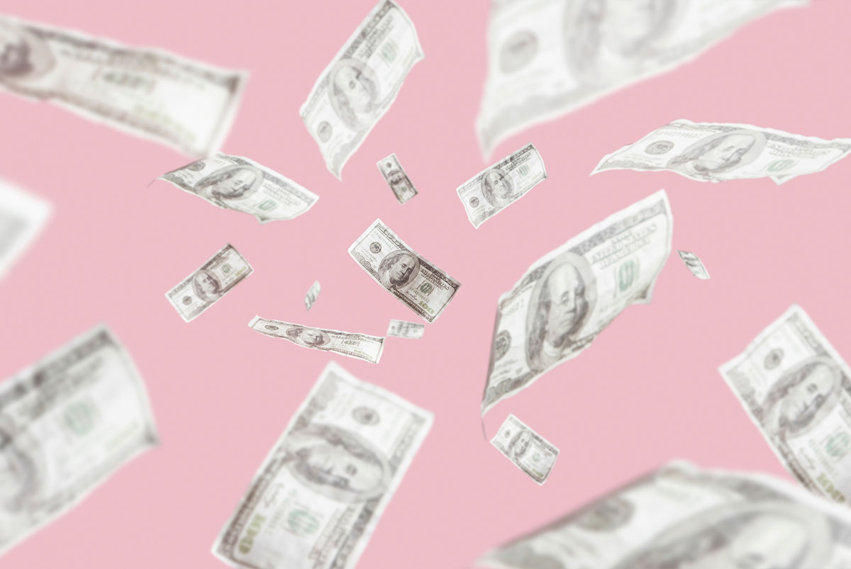 A pink background with money floating around