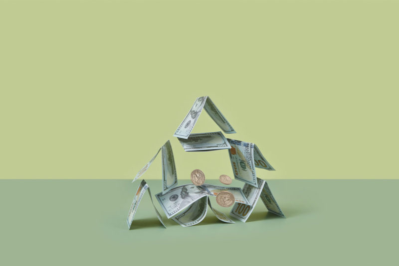 Dollars and cents falling on green background