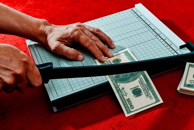 Money in a paper cutter
