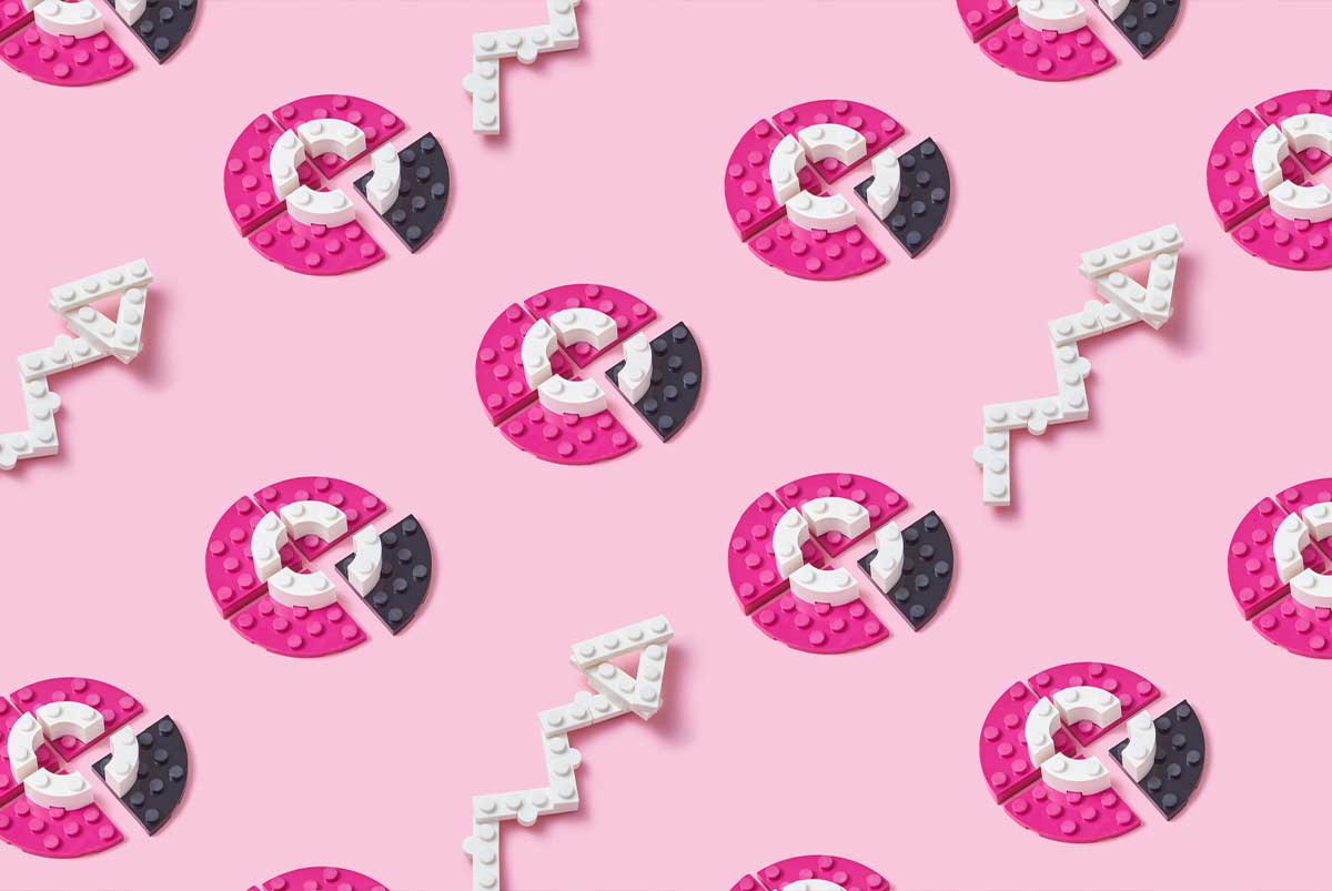 Lego circles and arrows on pink background