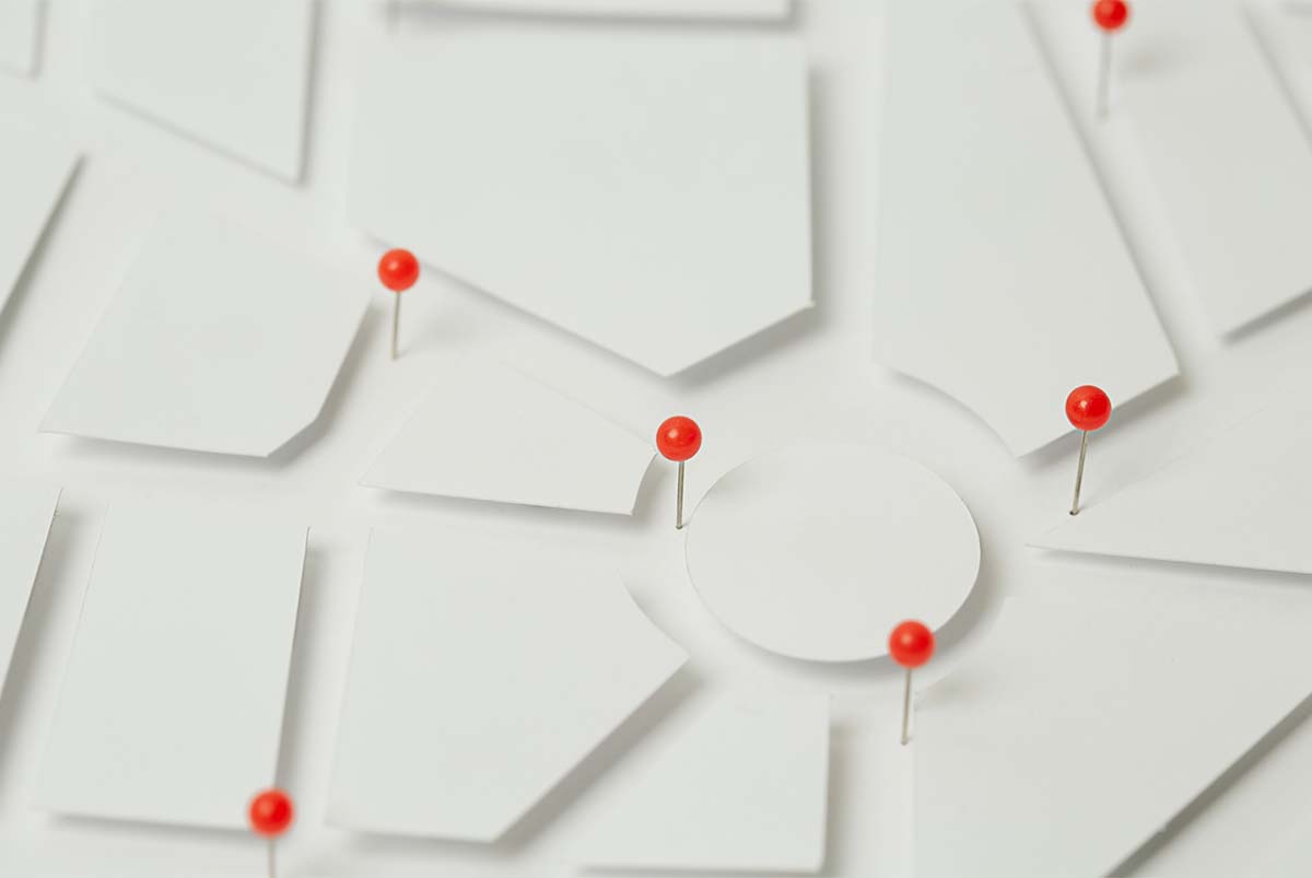 Red pins on white geometric map