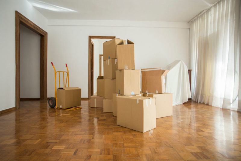 pile of boxes in a room to reflect selling your home topic
