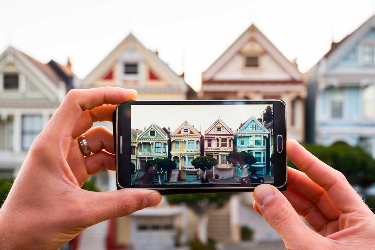 Photo of homes being taken on a smartphone