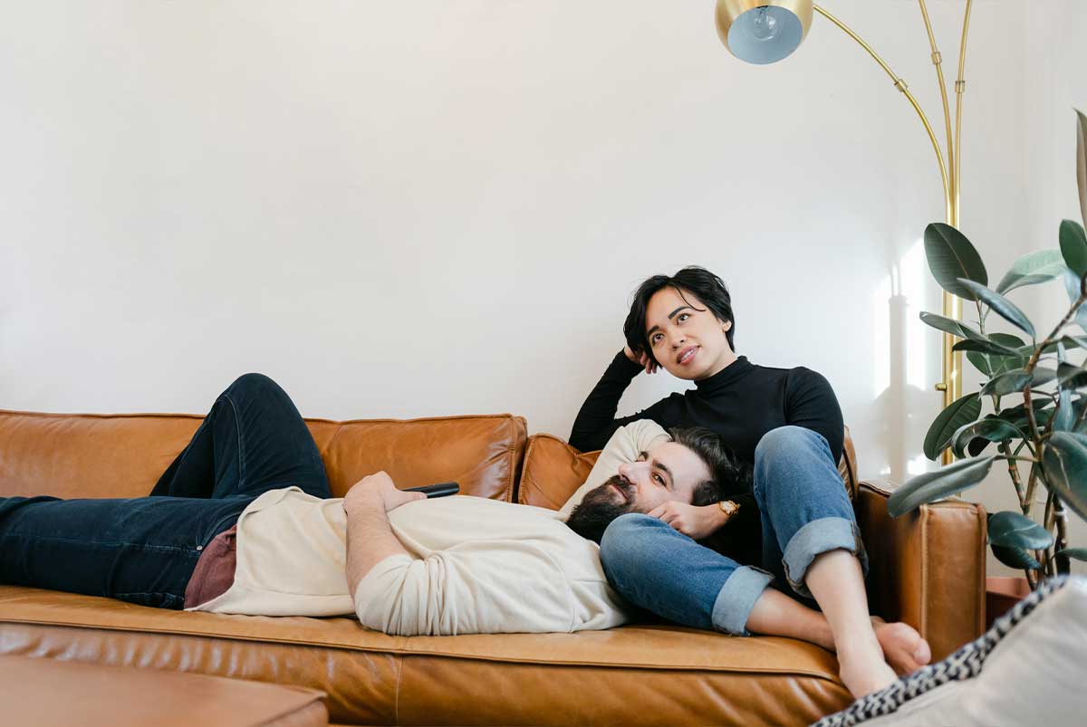 couple relaxing on sofa