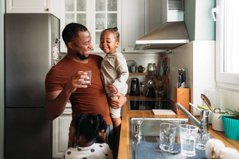Man and young child in kitchen