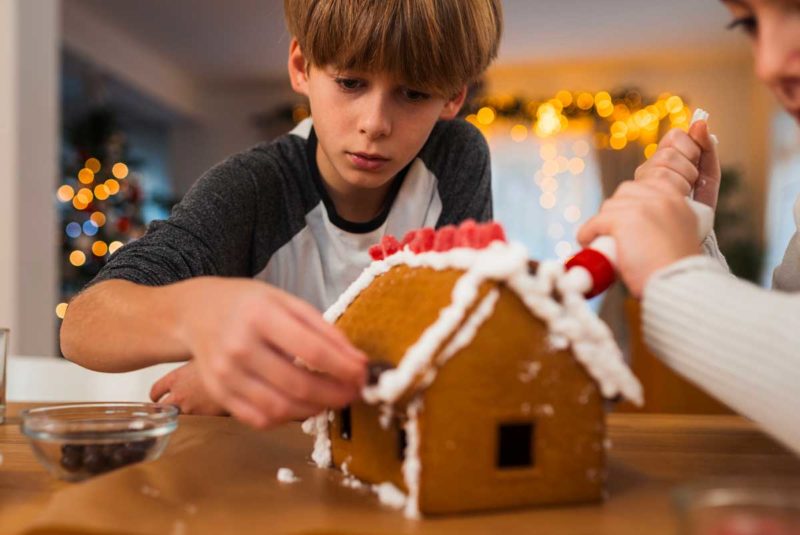 Kid building gingerbread house